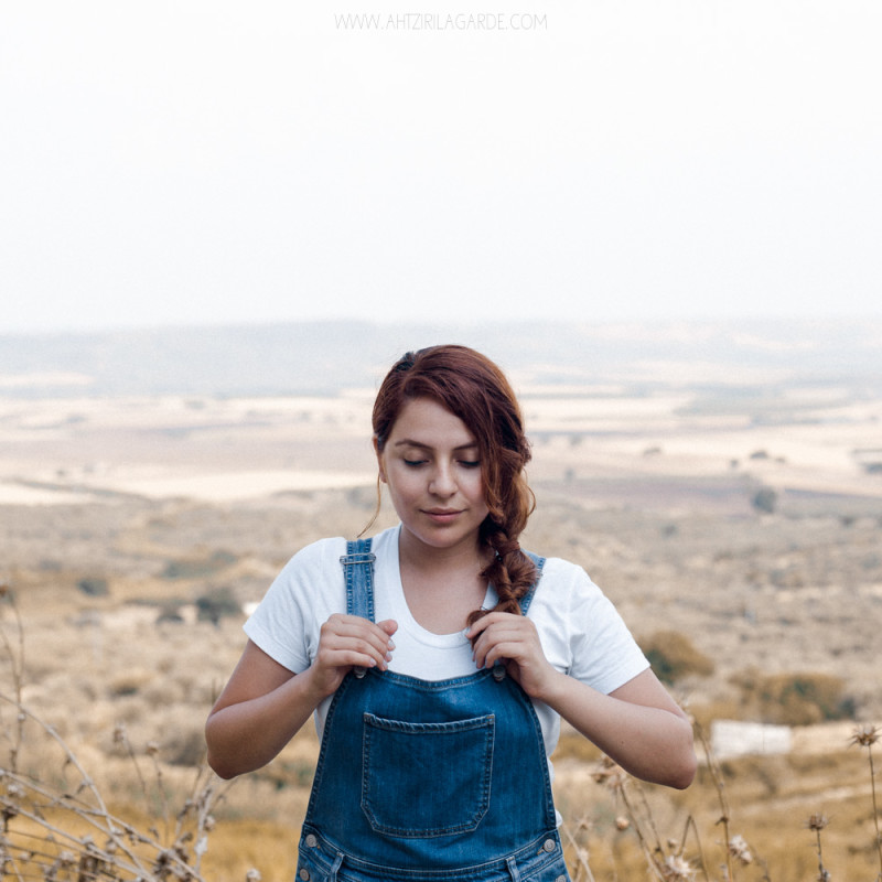 redhead in dungaree at yellow summer fields